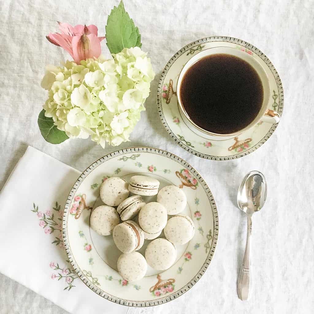 Macarons with a cup of coffee sitting on a table