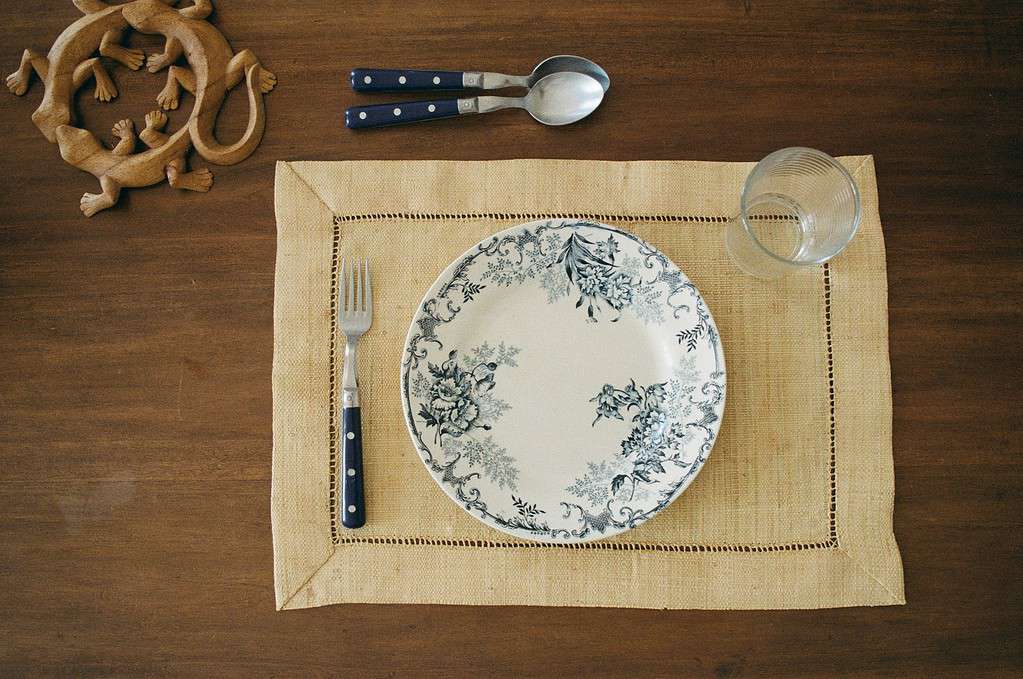 place setting with plate and glass and utensils