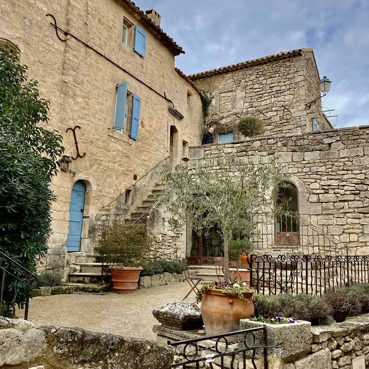 Old Provencal stone building with courtyard and steps