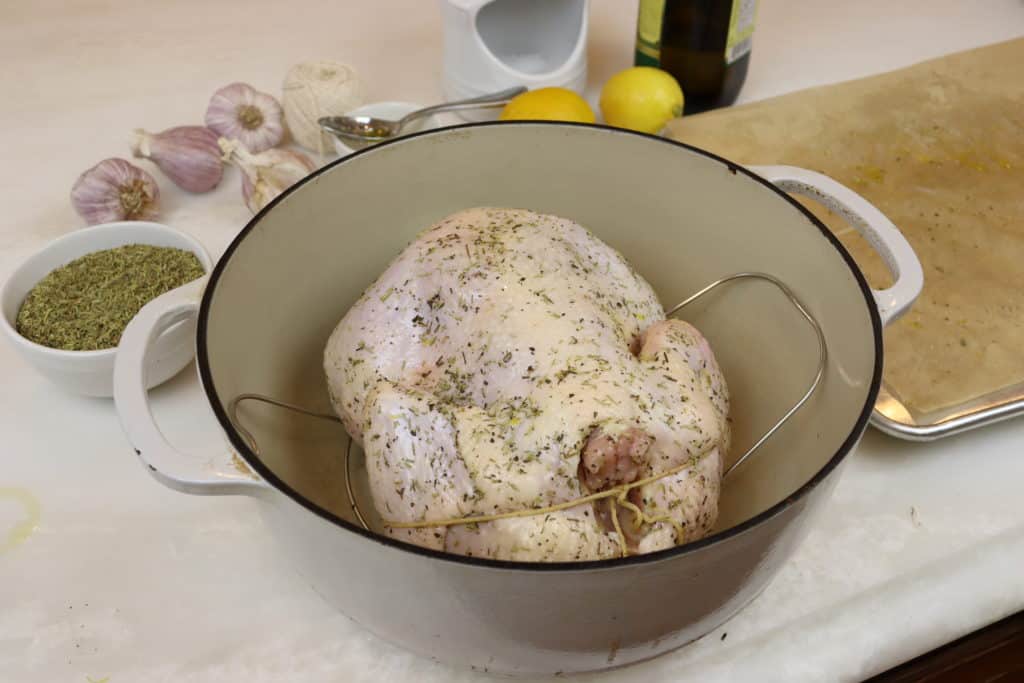 Raw roasted chicken in dutch oven