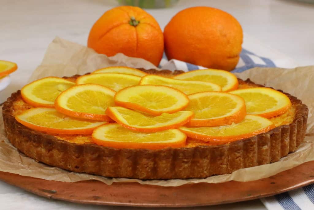 Orange Tart with oranges in the background.