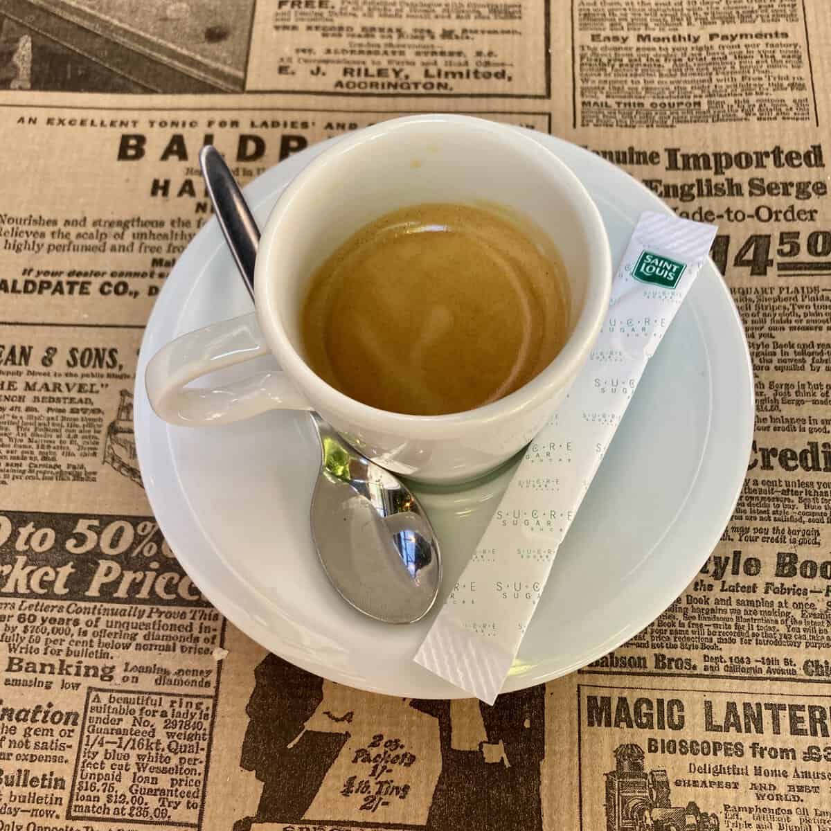 Close up of an espresso coffee on top of a newspaper