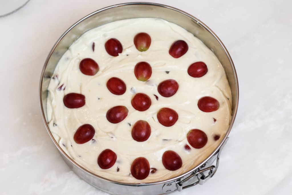 Grape halves arranged on top of unbaked cake batter.