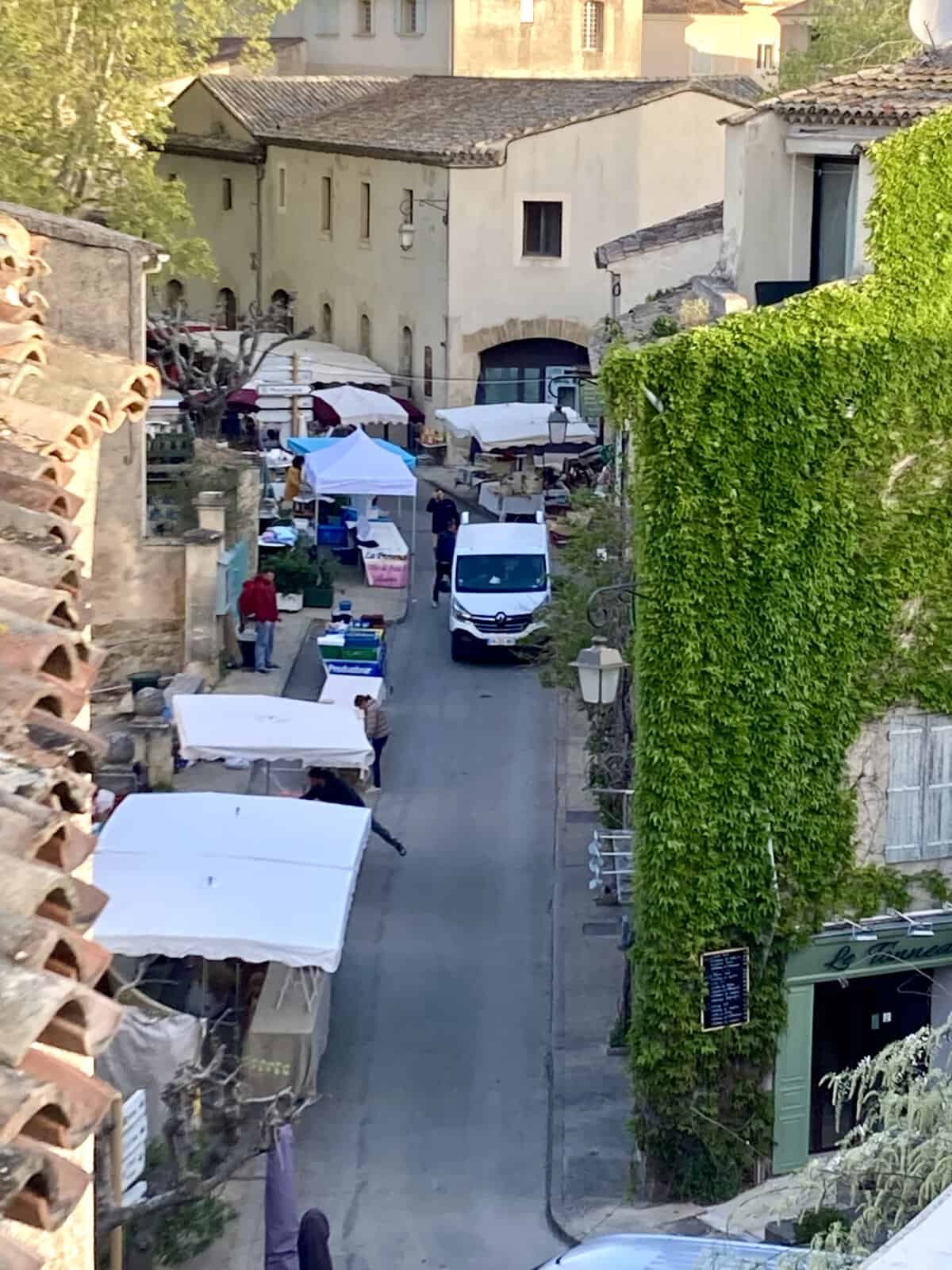 Street with van and Market umbrellas in Lourmarin