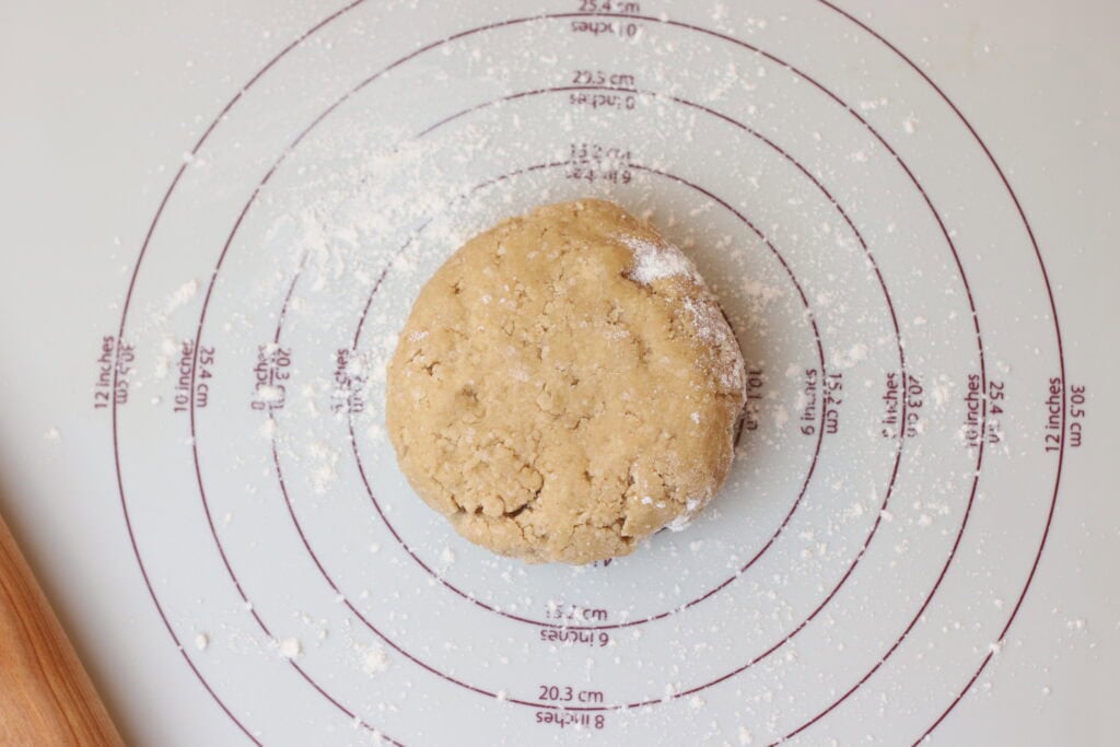 Soft French shortbread dough on a measuring mat, ready for baking, showcasing the art of French pastry-making and baking techniques.