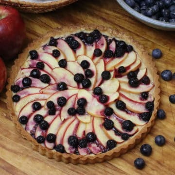 Apple Blueberry tart on a wooden board, taken from above