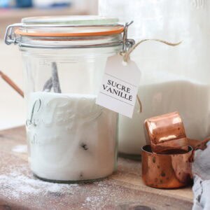 Cream and vanilla sugar jars with French-inspired kitchen decor for cozy, rustic baking and dessert making.